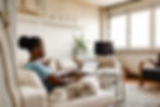 Woman working from home on a laptop with her dog beside her on the couch.