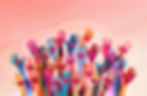 Vibrantly colored hands raised with heart symbols, symbolizing unity, love, and support in a cheerful background