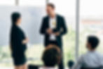 A man receiving an award at work from his colleagues