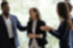 A woman being given praise about her contributions by her colleagues