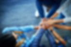Colleagues piling their hands together