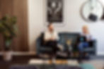 Two people having a meeting in an office lounge area and smiling