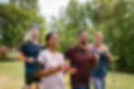 A group of people running outdoors, looking happy
