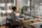 A woman working from home in a videocall with many people
