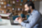 A man is talking to the camera on a videocall