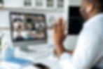 A man working from home and saying hi to his colleagues on a video call