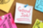 A 'Good Job!' compliment written on a pink sticky note surrounded by other notes.