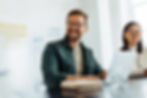 A man smiling in a meeting
