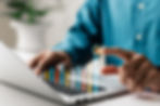 A person working on a laptop and an illustration of growth in the business