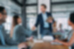 Employees during a meeting, and two of them shaking hands
