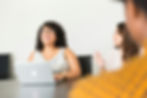 A woman smiling during a meeting in the office