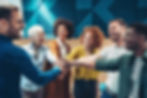 Team of diverse professionals putting their hands together in a show of unity and teamwork.