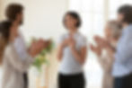 A woman at work being applauded