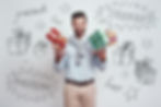 A man holding gifts in front of a whiteboard that says presents