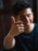 A man smiling and giving a thumbs up