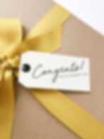A wrapped gift and a card that says congratulations