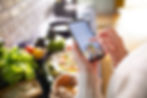 Person using a smartphone to browse healthy recipes.