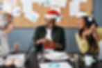 Shot of a group of businesspeople exchanging Christmas gifts in a modern office