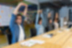 Group of colleagues stretching together during a casual office break, promoting wellness and relaxation