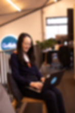 An employee working in the GoGift office on a laptop