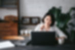 A woman working in her laptop at a cafe