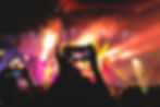 A lively concert being recorded through a phone