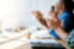 People in a meeting applauding