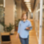 A woman walking in the office, smiling