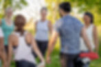 A group of people dressed for sports and stretching outdoors