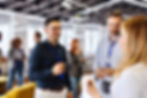 Group of professionals having a casual conversation and coffee during a networking event.