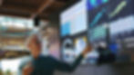 A professional man presenting data on a large screen, showing charts, graphs, and analytics in a tech-driven environment.