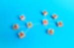 Wooden blocks connected by white lines on a blue background, representing a network of people or organizational structure.