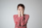A woman covers her eyes
