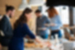 A buffet setup with people serving themselves, enjoying a meal in a casual restaurant setting.