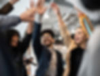 Work colleagues high-fiving together and celebrating