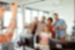 Group of colleagues posing for a photo together in an office, smiling and enjoying the moment.