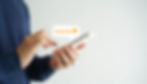 Hands holding a smartphone with a five-star rating speech bubble above it.