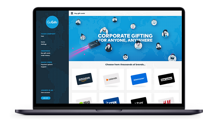 Laptop screen showing a corporate gifting web page with a slogan "CORPORATE GIFTING FOR ANYONE, ANYWHERE" and a selection of gift card options from various brands, part of the "GoGift" service platform.