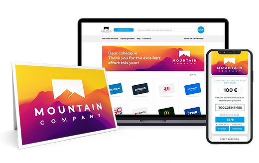 A set of corporate gift items including a greeting card from "MOUNTAIN COMPANY," a laptop screen with a thank you message, and a mobile phone displaying a 100 Euro digital gift card.